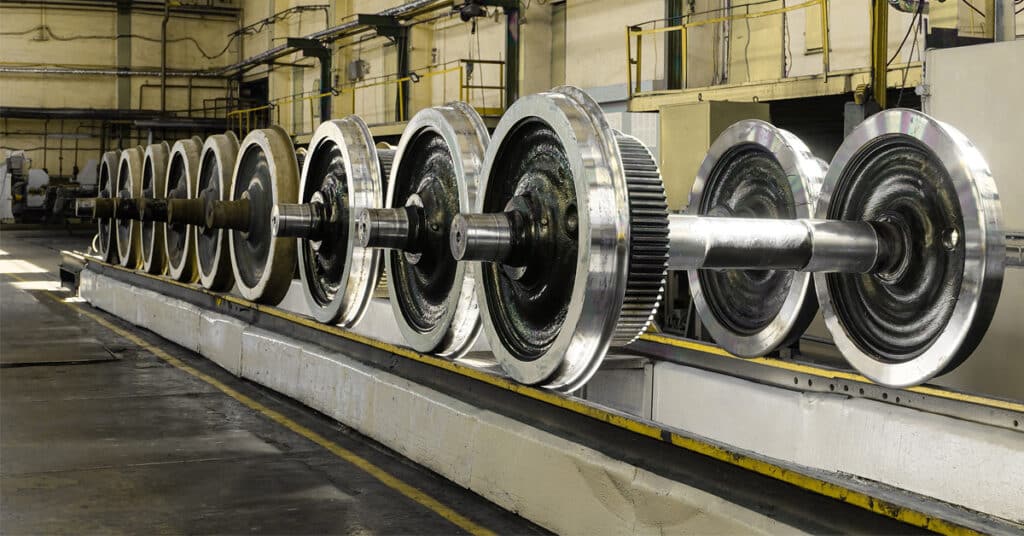 Steel railcar wheels await maintenance.