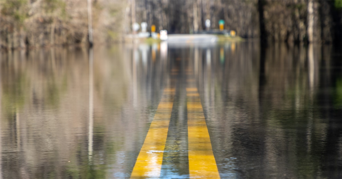 A road underwater with just the yellow lines visible.