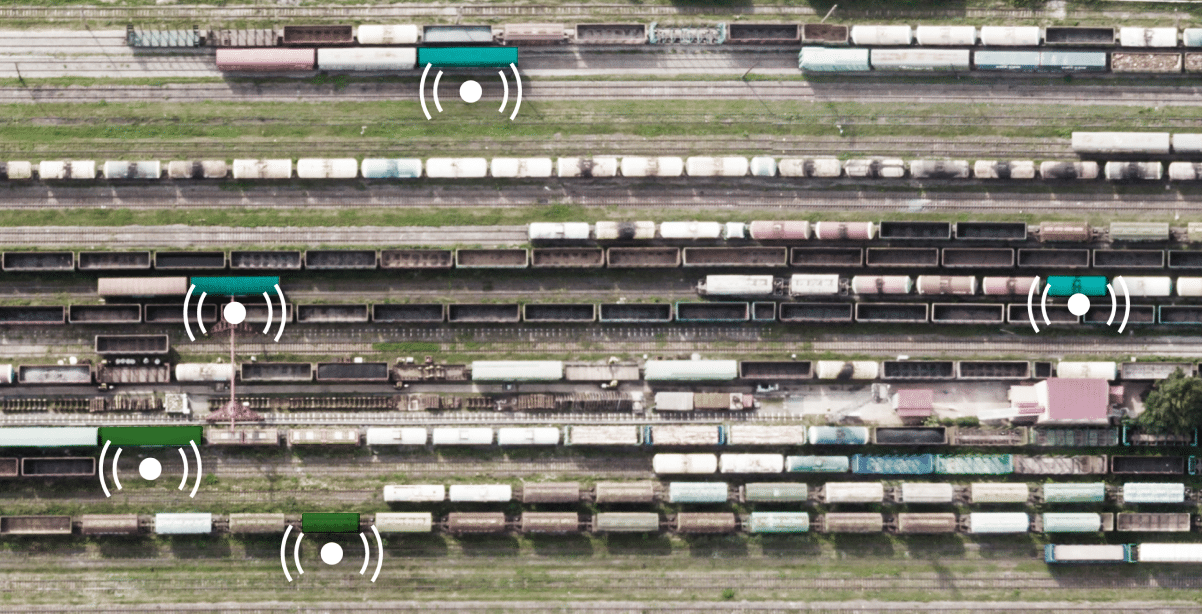 A rail yard with yard management indicators overtop the lines of rail cars.